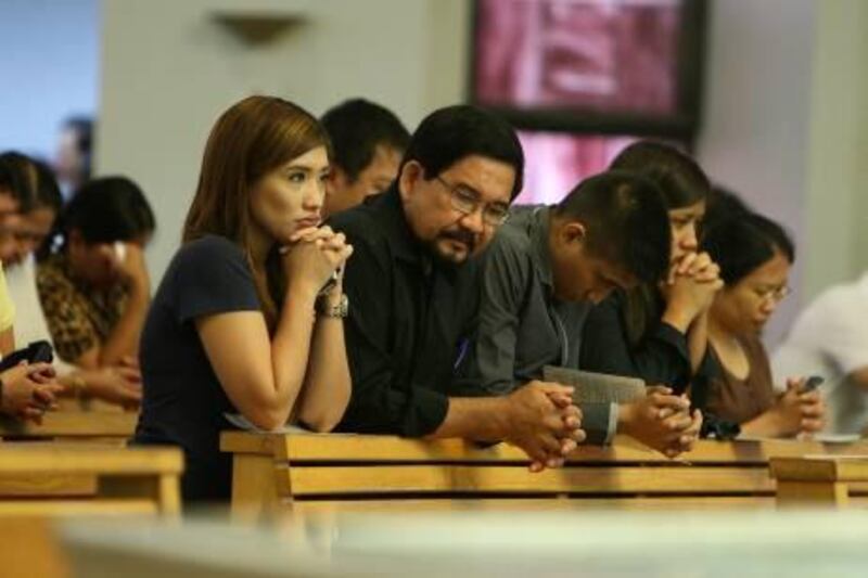
DUBAI , UNITED ARAB EMIRATES Ð Sep 8 : Left to Right - Lourdes , Pablo Varona , Louis and Lisa family members of Lorna Lim Varona during the eulogy mass held at St . Mary Õ s Church in Dubai. ( Pawan Singh / The National ) For  News. Story by Ramona