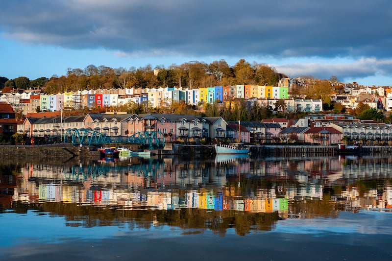 Colourful houses reflected in the River Frome in Bristol. Getty Images