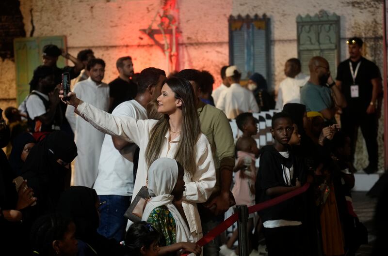 A tourist takes a picture during the popular Jeddah Season arts festival. AP