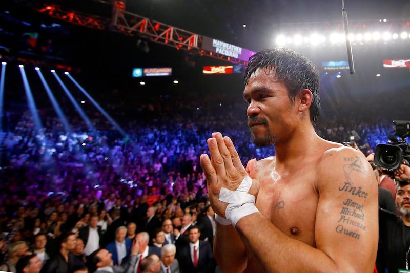 Manny Pacquiao gestures to the crowd after losing to Floyd Mayweather. Getty