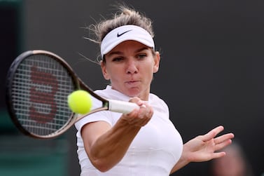 Romania's Simona Halep returns the ball to Poland's Magdalena Frech during their women's singles tennis match on the sixth day of the 2022 Wimbledon Championships at The All England Tennis Club in Wimbledon, southwest London, on July 2, 2022.  (Photo by Adrian DENNIS  /  AFP)  /  RESTRICTED TO EDITORIAL USE