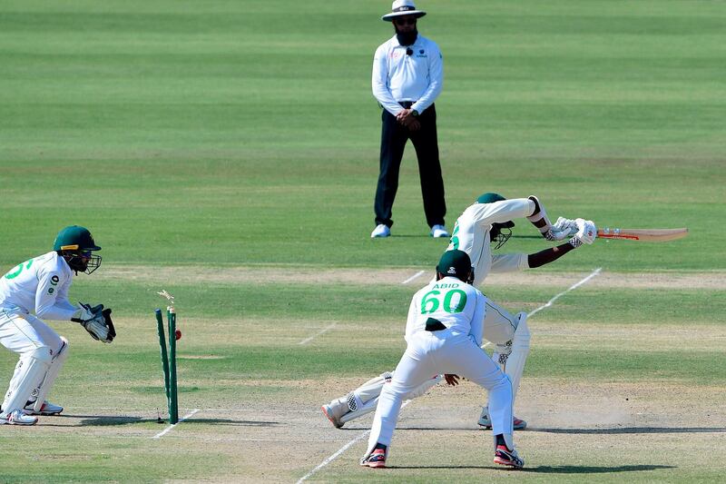 South Africa's Kagiso Rabada, right, is bowled out by Pakistan's Nauman Ali. AFP