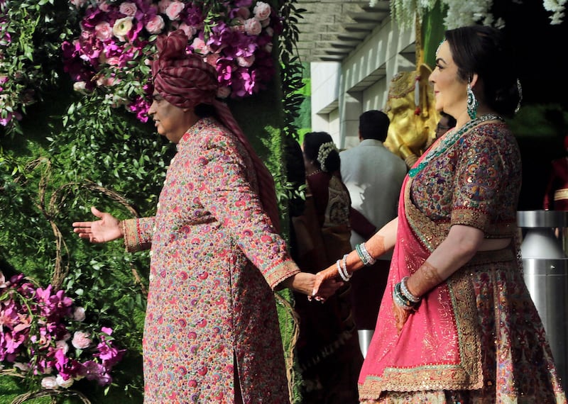 Reliance Industries Chairman Mukesh Ambani and his wife Nita Ambani welcome guests during the wedding of their son Akash Ambani in Mumbai, India, Saturday, March 9, 2019. Photo: AP