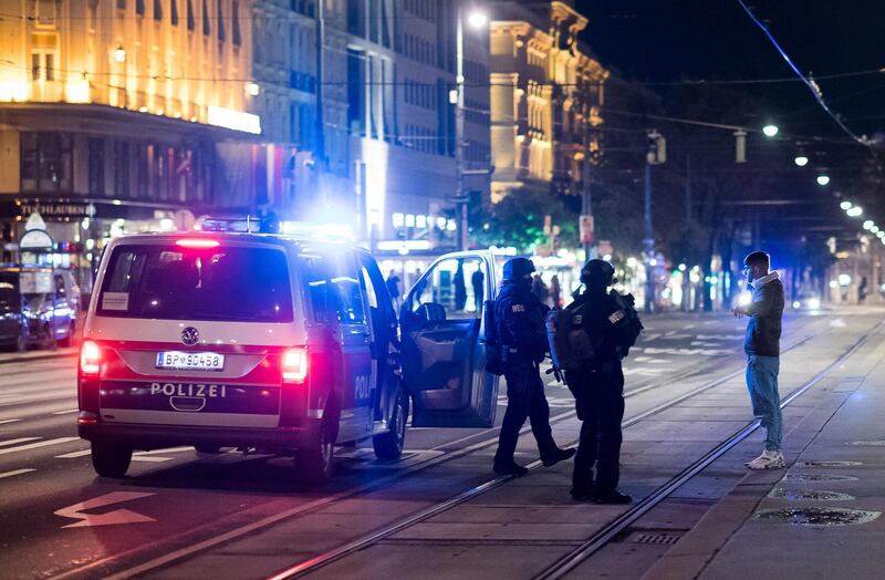 Heavily armed police speak to a passerby near the Vienna State Opera following a terrorist gun attack. Getty Images