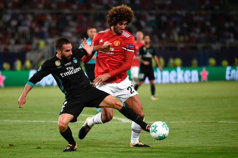 Manchester United's Marouane Fellaini challenges Real Madrid's Dani Carvajal. Nikolay Doychinov / AFP