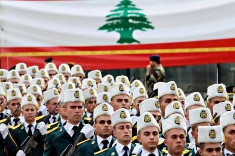 Lebanese army cadets march past a giant national flag during a military parade marking Lebanon's 69th independence day in central Beirut.