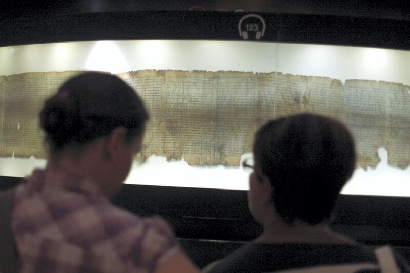 JERUSALEM, ISRAEL - SEPTEMBER 26: Tourists looks at  a replica of the Dead Sea Scrolls on display, inside the Shrine of the Book building at the Israel Museum on September, 26, 2011. in Jerusalem, Israel. For the first time some of the Dead Sea Scrolls are available online thanks to a partnership between Google and Israel‚Äôs national museum. (Photo by Lior Mizrahi/Getty Images)