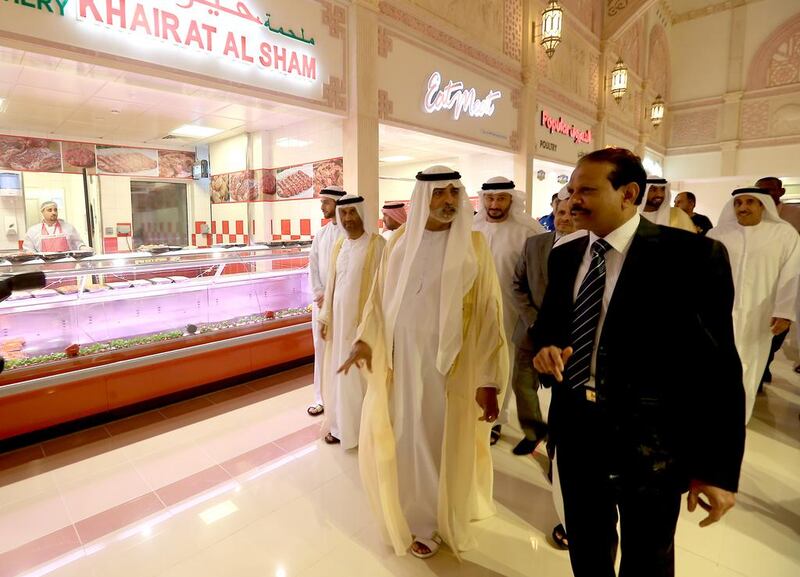 Sheikh Nahyan Bin Mubarak Al Nahyan, the Minister of Culture, Youth and Community Development, centre, and M A Yousuf Ali, right, the managing director of EMKE LuLu Group, tour the Market at Mushrif Mall shortly after its grand opening yesterday in Abu Dhabi. Ravindranath K / The National