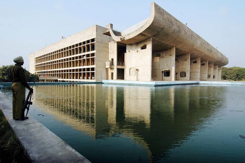 An Indian guard stands beside the Assembly Building in Chandigarh (AFP / NARINDER NANU)