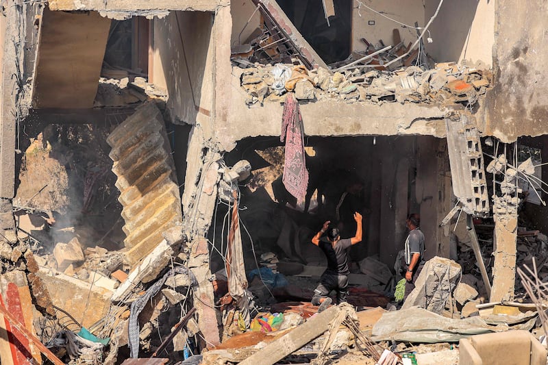 People search for survivors and bodies after a building was hit by Israeli bombing in Khan Younis in the southern Gaza Strip. AFP