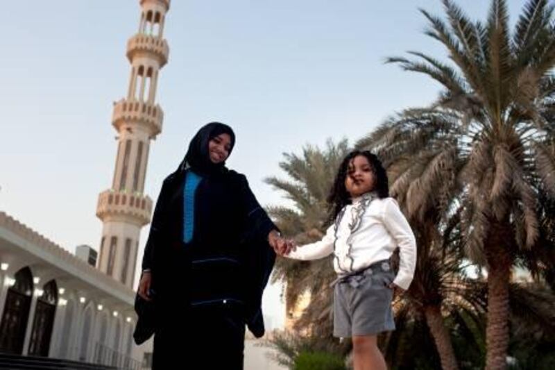 Full-time worker and a mother of two, Noura al Falahi poses for a portrait with her 3-year-old daughter Ghala al Remethi on Sunday, Jan. 1, 2012, in the her neighborhood in Abu Dhabi.  (Silvia Razgova/The National)
