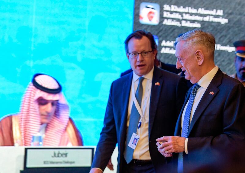 US Defence Secretary James Mattis (R) walks by as Saudi Arabia's Foreign Minister Adel Al-Jubeir (L) is seen on a screen addressing the 14th International Institute for Strategic Studies (IISS) Manama Dialogue in the Bahraini capital on October 27, 2018.  / AFP / STRINGER
