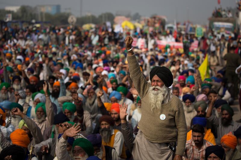 An elderly farmers shouts slogans as others listen to a speaker as they block a major highway during a protest at the Delhi-Haryana state border, India.  Talks between protesting farmers and the Indian government failed.  AP