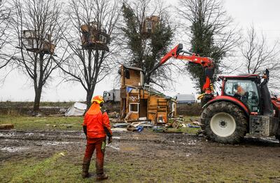 A digger demolishes a wooden house put up by activists in Luetzerath. EPA 