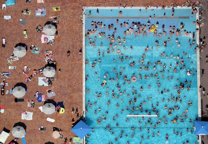 An aerial view showing people enjoying a sunny and hot day at the public outdoor pool 'Grugabad' in Essen, Germany.  EPA