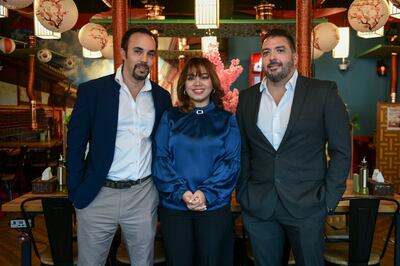 From left, Doug and Jenny Segalowitz with James Gaujardo, the partner at and business manager of Mukbang Shows Restaurant. Khushnum Bhandari / The National