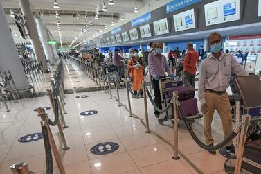 Indian nationals queue to check in at the Dubai International Airport. A massive exercise has been launched by the Indian government to bring home hundreds of thousands of Indians amid the coronavirus pandemic. AFP 