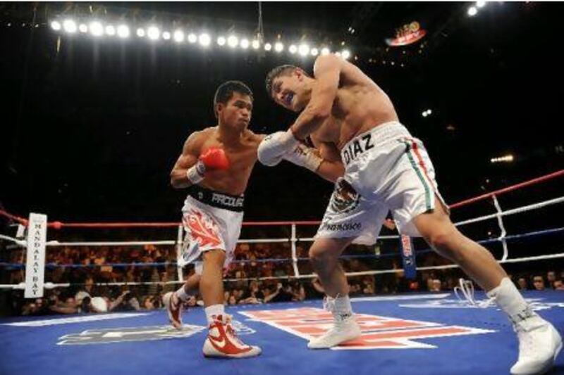 Manny Pacquiao on the offensive against David Diaz during their WBC Lightweight fight in 2008. Pacquiao floored Diaz in the ninth round to win his fourth title in four weight divisions. 

HARRY HOW / GETTY IMAGES
