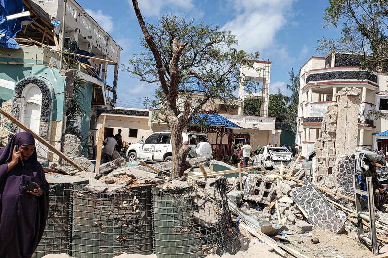 A view taken on July 13, 2019 shows the rubbles of the popular Medina hotel of Kismayo, a day after at least 26 people, including several foreigners, were killed and 56 injured in a suicide bomb and gun attack claimed by Al-Shabaab militants. A suicide bomber rammed a vehicle loaded with explosives into the Medina hotel in the port town of Kismayo before several heavily armed gunmen forced their way inside, shooting as they went, authorities said. / AFP / STRINGER
