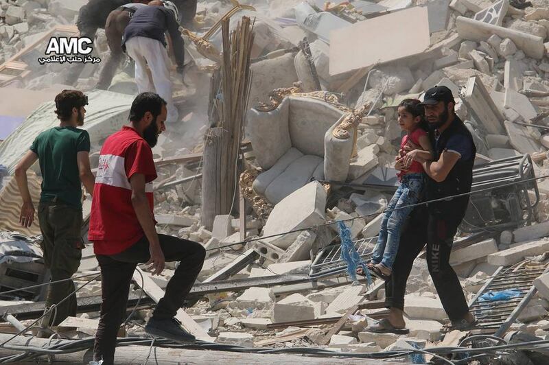 A child is carried away from the rubble of building destroyed by barrel bombs in the Bab Al Nairab district of Aleppo on August 27, 2016, when nearly 100 children were killed in a single week.  Photo: Aleppo Media Center via AP