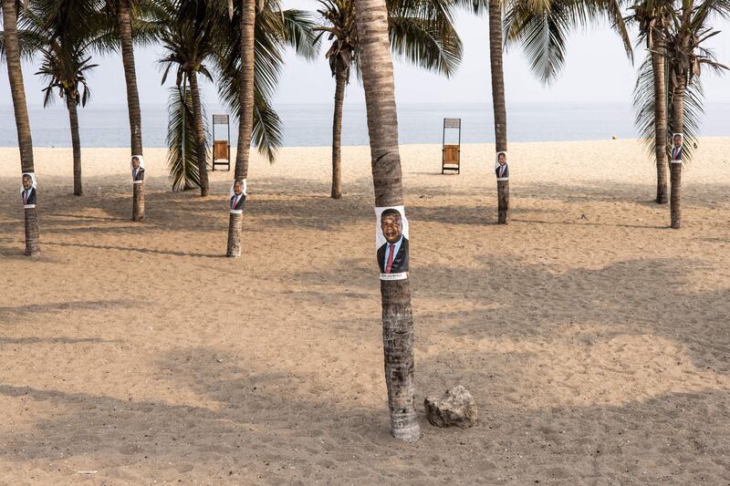 Campaign posters for Joao Lourenco on palm trees along the beach front in Luanda. AFP