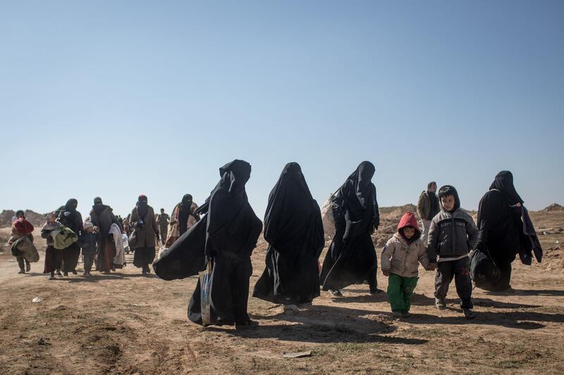 Civilians who have fled fighting in Bagouz wait to board trucks. Getty Images