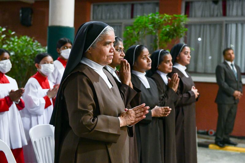 Nuns pray during Christmas Eve midnight mass at St Joseph's Cathedral, Abu Dhabi. Khushnum Bhandari / The National
