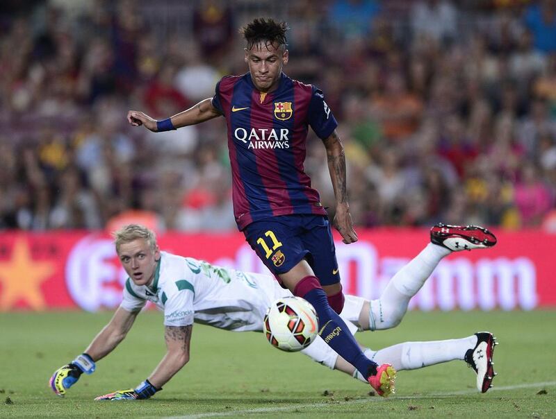 Barcelona forward Neymar scores past Leon's goalkeeper William Yarbrough during their friendly on Monday at the Camp Nou. Josep Lago / AFP  

