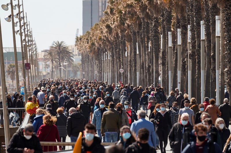 People walk along a promenade in Barcelona, Spain. EPA