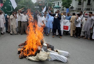 Pakistani clerks shout anti India slogans after burning effigies of Indian Prime Minster Narendra Modi during a protest to express support and solidarity with Indian Kashmiri people in their peaceful struggle for their right to self-determination, in Lahore, Pakistan, Tuesday, Aug. 6, 2019. India's government has revoked disputed Kashmir's special status by a presidential order as thousands of troops patrolled and internet and phone services were suspended in the region where most people oppose Indian rule. (AP Photo/K.M. Chaudary)