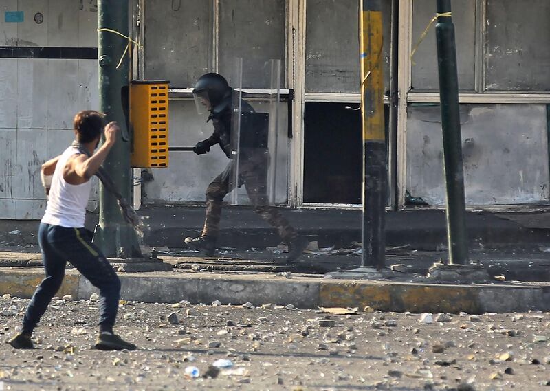 Iraqi protesters clash with Iraqi security forces at Baghdad's Khallani square during ongoing anti-government demonstrations on November 11, 2019.  AFP