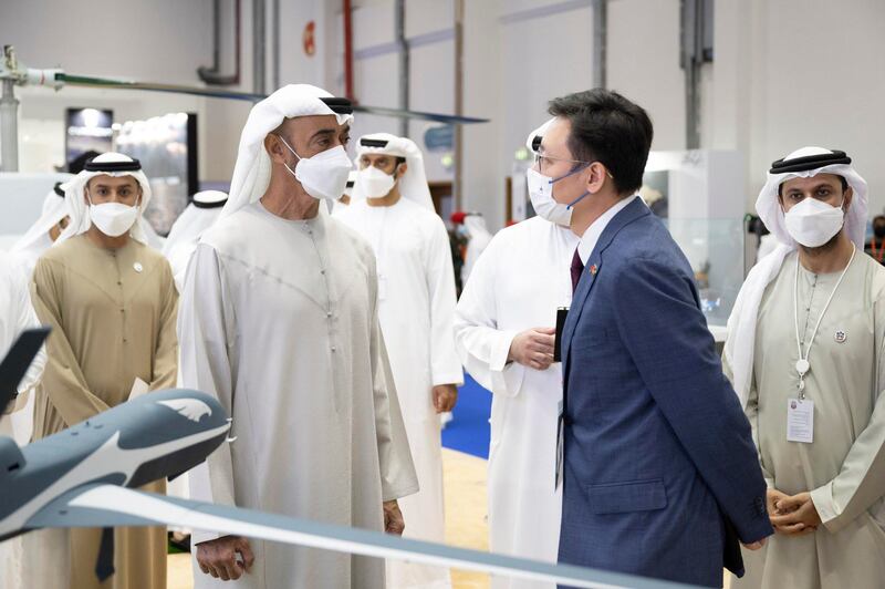 Sheikh Mohamed bin Zayed, Crown Prince of Abu Dhabi and Deputy Supreme Commander of the Armed Forces, discusses an exhibit.