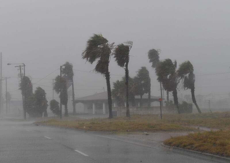 Strong winds batter a house on Padre Island before the approaching Hurricane Harvey in Corpus Christi, Texas on August 25, 2017.
Hurricane Harvey will soon hit the Texas coast with forecasters saying it is possible expect up to 3 feet of rain and 125 mph winds. / AFP PHOTO / MARK RALSTON