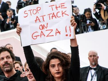 Lebanese actress Manal Issa, from 'My Favourite Fabric', protests at the premiere of 'Solo: A Star Wars Story' at Cannes on Tuesday, after Israeli soldiers killed 60 Palestinians and wounded hundreds in mass protests on the Gaza border on Monday. With Issa are filmmakers Etienne Kallos, second left, and Gaya Jiji, second right. AP