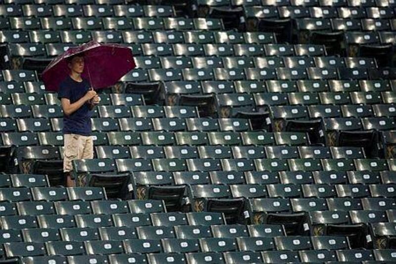 A fan waits out the rain during a delayed start of the game between the Cleveland Indians and the Tampa Bay Rays earlier this season. Tampa Bay has strated to flirt with the idea of moving the club to Montreal. Jason Miller/Getty Images