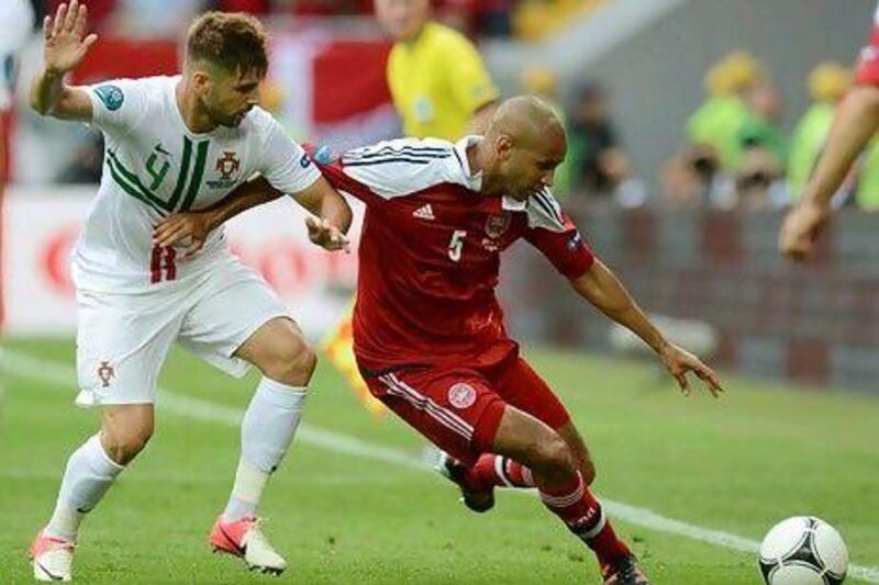 Portugal's Miguel Veloso, left, vies with Denmark's Simon Poulsen.