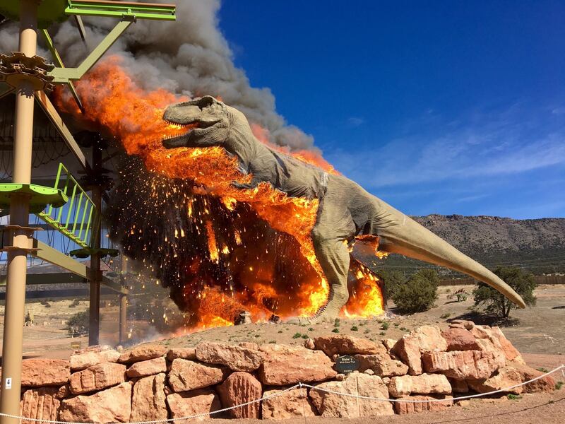 Smoke rises from a replica of a T-Rex after it burst into flames at the Royal Gorge Dinosaur Experience in Canon City, Colorado, US.. Royal Gorge Dinosaur Experience / via Reuters