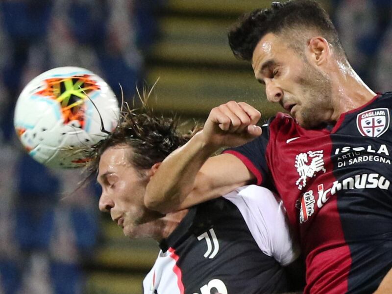 Cagliari's Charalampos Lykogiannis and Juventus' Federico Bernardeschi attempt to head the ball. EPA