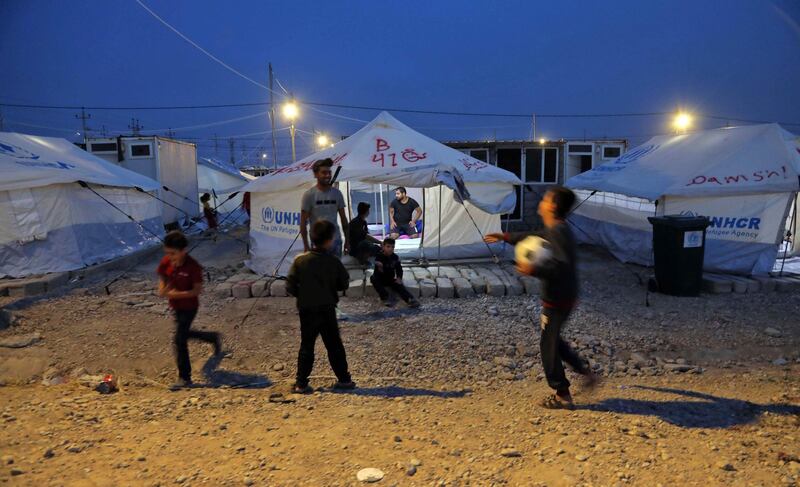 Syrian children, who have been recently-turned refugees by the Turkish military operation in northeastern Syria, play football outside a tent at the Bardarash camp, near the Kurdish city of Dohuk, in Iraq's autonomous Kurdish region. AFP