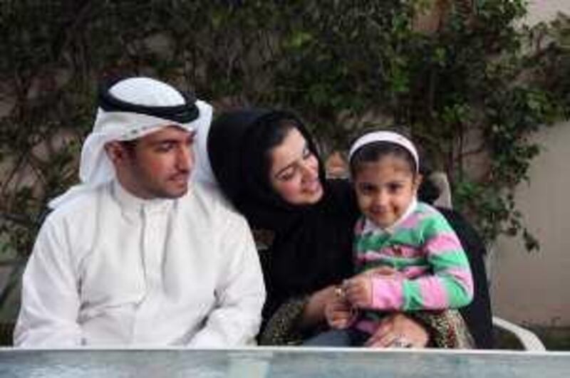 DUBAI, UNITED ARAB EMIRATES - JANUARY 13:  Dr Mohammad Al Redha, Head of Planning & Development, Dubai Health Authority, pictured at home with his wife, Amal, who works as a senior analyst at Dubai Cares, and daughter Shahad, 3.5 years old, in Dubai on January 13, 2010. Dr Al Redha also has a 10-month-old son, Yousuf (not pictured).  (Randi Sokoloff / The National)  For News story by Zoi Constantine.
 *** Local Caption ***  RS002-011310-AL-REDHA.jpg