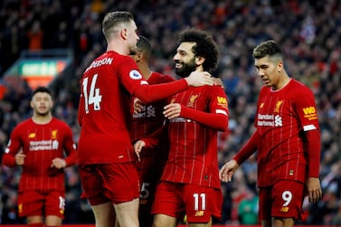 Liverpool's Mohamed Salah celebrates with Jordan Henderson and teammates. Reuters