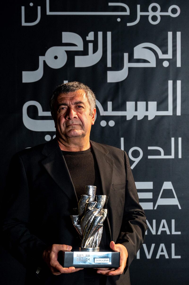 Kurdish-Swiss film director Mano Khalil posing with his Best Screenplay award for his film 'Neighbours'. Photo: Red Sea International Film Festival / AFP