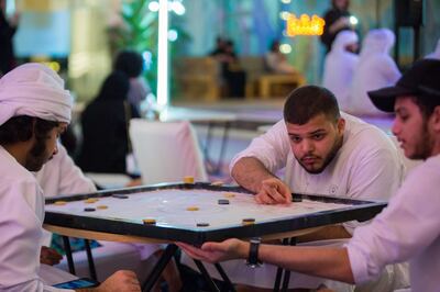Visitors to the 2018 Ramadan Arcade taking part in a game of Carrom. Courtesy Manarat Al Saadiyat