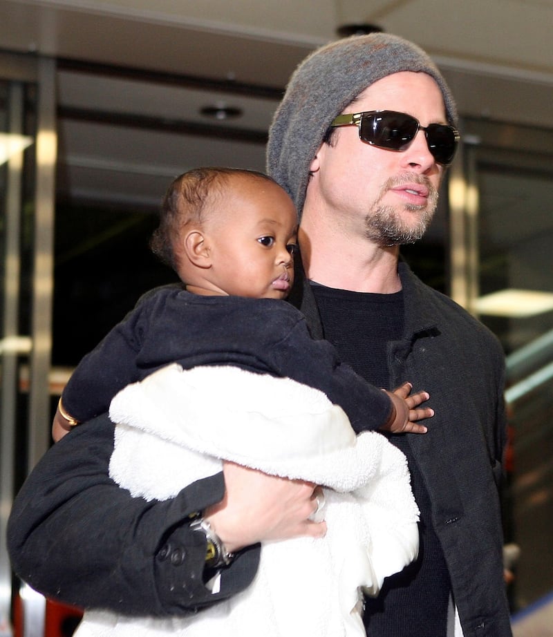 NARITA, JAPAN - NOVEMBER 27:  Actor Brad Pitt holds Zahara Marley Jolie (Angelina Jolie's daughter) as they arrive at the New Tokyo International Airport on November 27, 2005 in Narita, Japan. Pitt and Angelina Jolie are in Japan to promote a film "Mr. and Mrs. Smith."  (Photo by Koichi Kamoshida/Getty Images)