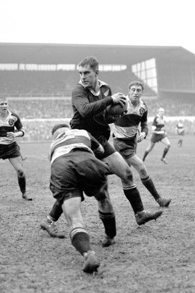 The Barbarians' Ian Clarke tackles New Zealand's Colin Meads at Cardiff Arms Park in 1964.