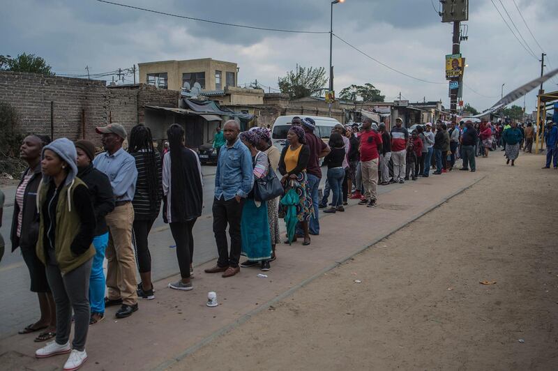 People queue to cast their votes in Diepsloot, near Johannesburg on Wednesday, May 8, 2019. South Africans are voting Wednesday in a national election that pits President Cyril Ramaphosa's ruling African National Congress against top opposition parties Democratic Alliance and Economic Freedom Fighters, 25 years after the end of apartheid. (AP Photo/Mujahid Safodien)