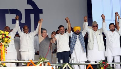 Leaders of the opposition parties comprising the INDIA alliance hold hands at the rally. EPA