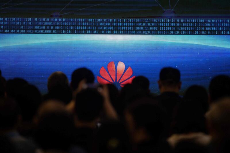 Guests and journalists attend the Huawei database and storage product launch during a press conference at the Huawei Beijing Executive Briefing Centre in  Beijing.  AFP