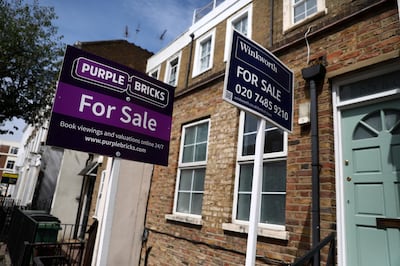 FILE PHOTO: Estate agent boards are displayed outside a property in London, Britain July 7, 2017. REUTERS/Neil Hall/File Photo
