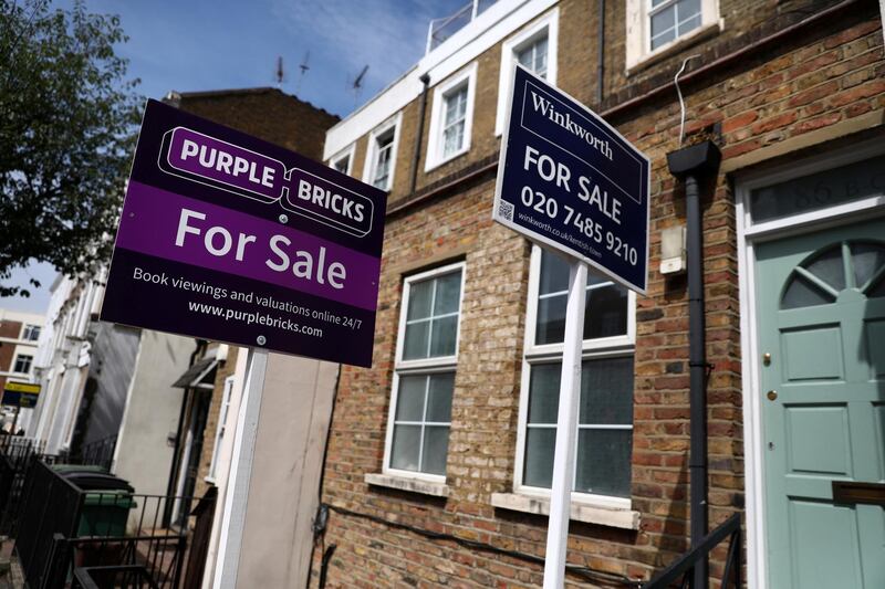 FILE PHOTO: Estate agent boards are displayed outside a property in London, Britain July 7, 2017. REUTERS/Neil Hall/File Photo